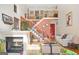 Bright living room featuring a fireplace, grand staircase, and elegant decor at 7523 Kimberly Lynn Ct, Lithonia, GA 30058