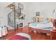 Bright main bedroom featuring hardwood floors, fireplace, spiral staircase and ensuite bathroom entrance at 7523 Kimberly Lynn Ct, Lithonia, GA 30058