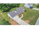 Aerial view showcases well-maintained landscaping, and long driveway at 90 Heatherstone Way, Covington, GA 30016