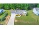Aerial view of the house showing a long driveway, and mature trees at 90 Heatherstone Way, Covington, GA 30016