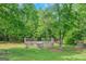 Wooden deck with multiple levels nestled in a private backyard setting among trees at 90 Heatherstone Way, Covington, GA 30016