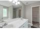 Bathroom with a double sink vanity, large mirror, and neutral paint at 90 Heatherstone Way, Covington, GA 30016