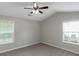 Bedroom features ceiling fan and two windows for ample natural light at 90 Heatherstone Way, Covington, GA 30016