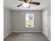 Bright bedroom with carpeted floor, ceiling fan, and window at 90 Heatherstone Way, Covington, GA 30016