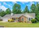 Charming single-story home with a stone accent wall and a well-manicured front yard at 90 Heatherstone Way, Covington, GA 30016