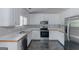 Bright kitchen with white cabinets, stainless steel appliances, and modern countertops at 90 Heatherstone Way, Covington, GA 30016