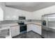 Bright kitchen featuring white cabinets, stainless steel appliances, and modern backsplash at 90 Heatherstone Way, Covington, GA 30016