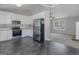 Open concept kitchen with stainless steel refrigerator and view to living room at 90 Heatherstone Way, Covington, GA 30016