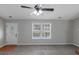 Comfortable living room with carpet, a ceiling fan, and a large window at 90 Heatherstone Way, Covington, GA 30016