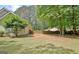Spacious backyard featuring a private wooden fence and mature trees, perfect for outdoor activities at 15 Riverside Pkwy, Sharpsburg, GA 30277