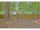 Backyard gate with security signage providing backyard access, backed by lush greenery at 15 Riverside Pkwy, Sharpsburg, GA 30277