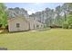 A well-maintained backyard features a spacious lawn, and a charming back deck, ideal for outdoor entertainment and relaxation at 15 Riverside Pkwy, Sharpsburg, GA 30277
