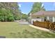The backyard features a well-maintained lawn, a wooden fence, and a charming deck, offering a private outdoor retreat at 15 Riverside Pkwy, Sharpsburg, GA 30277