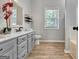 Bright bathroom features a stylish vanity, updated commode, natural light, and wood-look flooring at 15 Riverside Pkwy, Sharpsburg, GA 30277