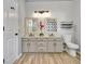 This bathroom has double sinks, new commode, stylish fixtures, and updated lighting at 15 Riverside Pkwy, Sharpsburg, GA 30277