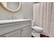 This bathroom features a modern vanity with a white countertop and a round mirror at 15 Riverside Pkwy, Sharpsburg, GA 30277