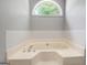 Large bathtub has tile surround and arched window with backyard view at 15 Riverside Pkwy, Sharpsburg, GA 30277