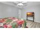 Bedroom with stylish quilt, ceiling fan, tray ceiling, and a television on stand at 15 Riverside Pkwy, Sharpsburg, GA 30277