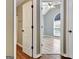 Bedroom with arched window, ceiling fan, and modern color scheme, seen through doorway at 15 Riverside Pkwy, Sharpsburg, GA 30277