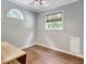 Bedroom with light gray walls, wood floors, and two windows for ample natural light at 15 Riverside Pkwy, Sharpsburg, GA 30277