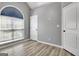 A bright bedroom featuring a vaulted ceiling, a large window, and wood-look flooring at 15 Riverside Pkwy, Sharpsburg, GA 30277