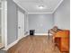 Bonus room features hardwood floors, neutral walls, and trim with natural light at 15 Riverside Pkwy, Sharpsburg, GA 30277