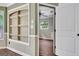 Dining area with wainscoting, built in shelving, and view into a bedroom at 15 Riverside Pkwy, Sharpsburg, GA 30277
