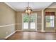 Elegant dining area with chandelier and french doors, perfect for entertaining or Gathering meals at 15 Riverside Pkwy, Sharpsburg, GA 30277