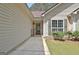 Cozy home entrance with a decorative glass door, surrounded by manicured landscaping and a 