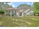 Charming single story home featuring a manicured lawn, cozy exterior, and beautiful landscaping at 15 Riverside Pkwy, Sharpsburg, GA 30277