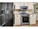 Kitchen with black refrigerator and stainless steel microwave and stove/oven at 15 Riverside Pkwy, Sharpsburg, GA 30277