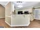 Kitchen with white cabinets, dark appliances, breakfast bar and wood floors at 15 Riverside Pkwy, Sharpsburg, GA 30277