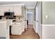 Kitchen with white cabinets, granite counters, wood floors, and stainless steel microwave at 15 Riverside Pkwy, Sharpsburg, GA 30277