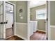 View of laundry room with machines and shelves, accessed via doorway, next to hallway at 15 Riverside Pkwy, Sharpsburg, GA 30277