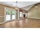 Well-lit living room with brick fireplace, french doors, and a vaulted ceiling offering a spacious feel at 15 Riverside Pkwy, Sharpsburg, GA 30277
