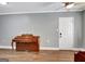 A piano adds character to the room, complemented by hardwood floors and natural light at 15 Riverside Pkwy, Sharpsburg, GA 30277