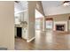 Open-concept living space with hardwood floors and a cozy fireplace, flowing seamlessly into the kitchen at 15 Riverside Pkwy, Sharpsburg, GA 30277
