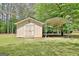 View of backyard shed and car portico, perfect for extra storage and car protection at 15 Riverside Pkwy, Sharpsburg, GA 30277