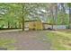 Backyard view showing a shed with an attached car portico area, providing additional covered space at 15 Riverside Pkwy, Sharpsburg, GA 30277