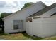 View of the backyard, featuring a privacy fence, grass and the side of the house at 214 Oak Cir, Stockbridge, GA 30281