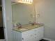 Bathroom featuring double vanity with granite countertop and large mirror at 214 Oak Cir, Stockbridge, GA 30281