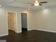 Spacious bedroom with closet, a fan and a door to the bathroom at 214 Oak Cir, Stockbridge, GA 30281