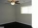 Cozy bedroom featuring a ceiling fan, window, and neutral walls at 214 Oak Cir, Stockbridge, GA 30281
