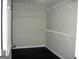 Walk-in closet with adjustable white wire shelving and dark flooring at 214 Oak Cir, Stockbridge, GA 30281