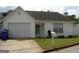 Charming single-story home featuring a one car garage, manicured lawn, and welcoming entrance at 214 Oak Cir, Stockbridge, GA 30281