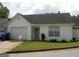 Single-story home featuring a one car garage, manicured lawn, and welcoming entrance at 214 Oak Cir, Stockbridge, GA 30281