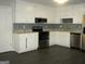 Modern kitchen with white cabinets, stainless steel appliances, and granite countertops at 214 Oak Cir, Stockbridge, GA 30281