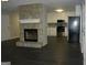 Open concept living room featuring a stone fireplace, modern flooring, and view of the kitchen at 214 Oak Cir, Stockbridge, GA 30281