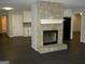 Inviting living room featuring a stone fireplace and modern flooring at 214 Oak Cir, Stockbridge, GA 30281