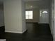 Open concept living room with view of the front door and large windows at 214 Oak Cir, Stockbridge, GA 30281